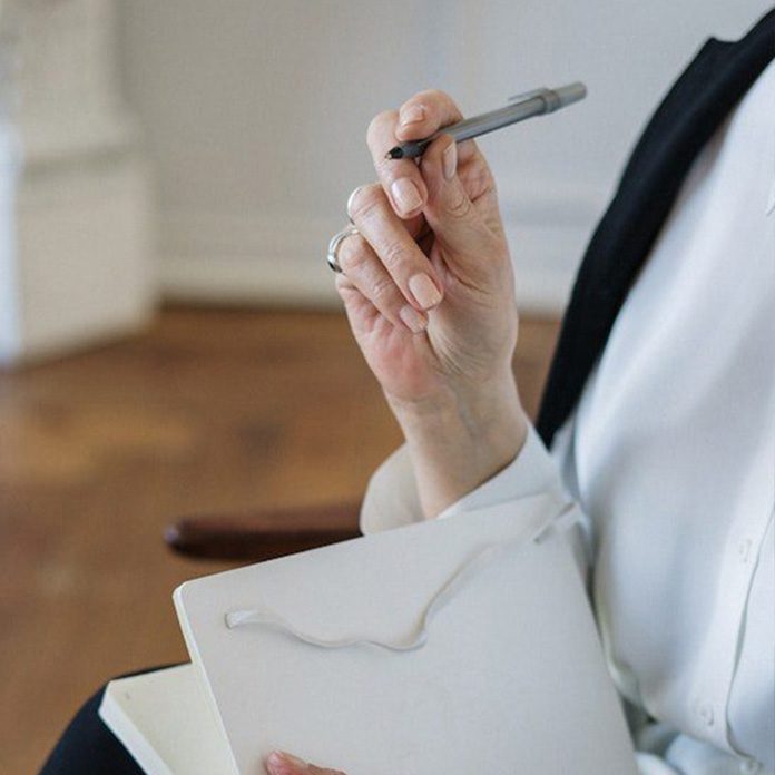 Person in White Dress Shirt Holding White Paper
